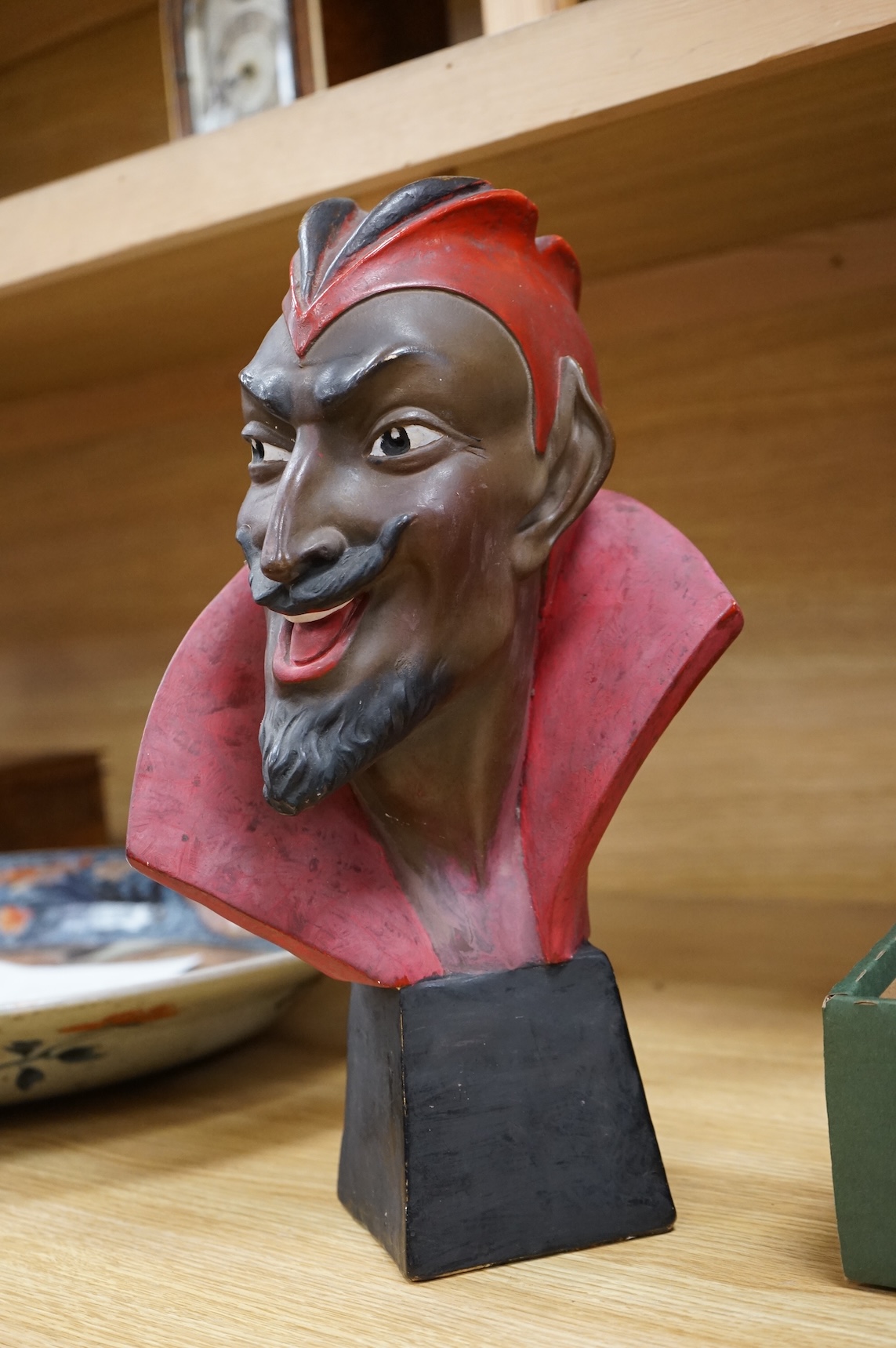 An Art Deco painted pottery bust of Mephistopheles, signed Joel Oni?, 38cm
